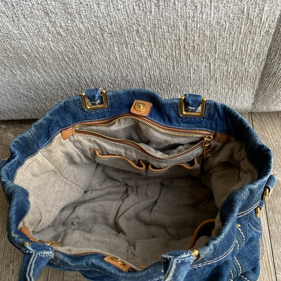 This is a Prada denim tote bag. No rips or tears, just minor wear from use. - Picture 5 of 9